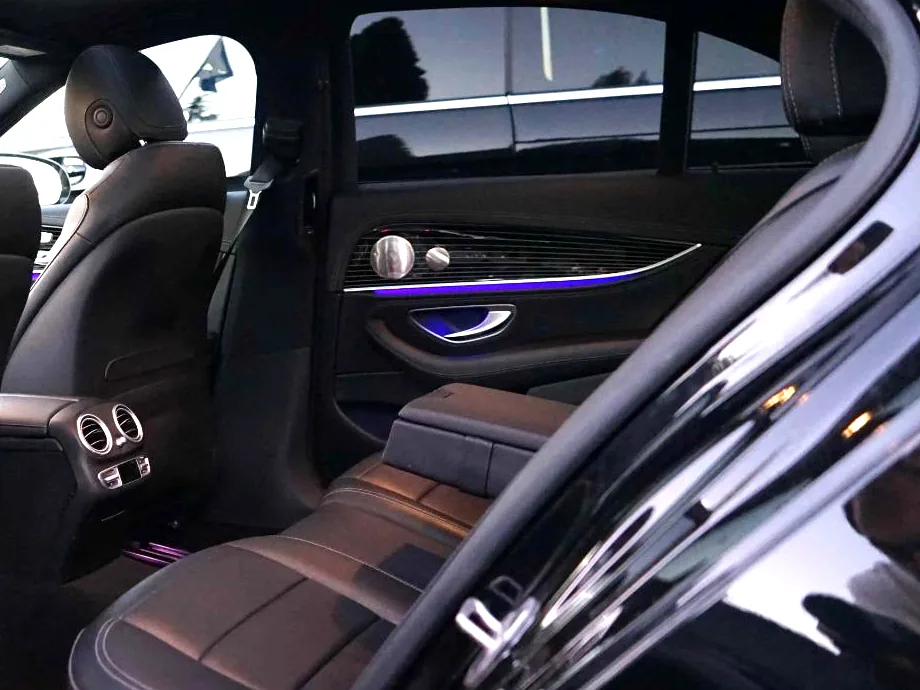 Rear seat of a Business Class sedan, seen through the open door