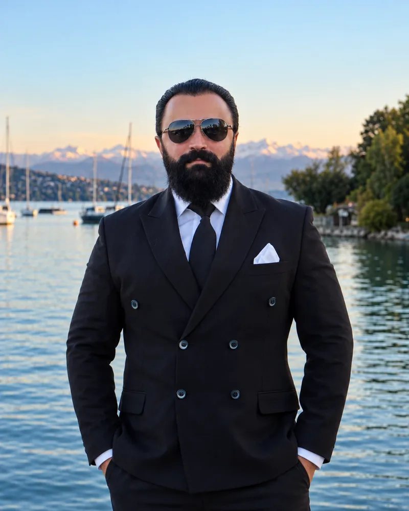 Chauffeur Ayhan in a double-breasted suit and sunglasses